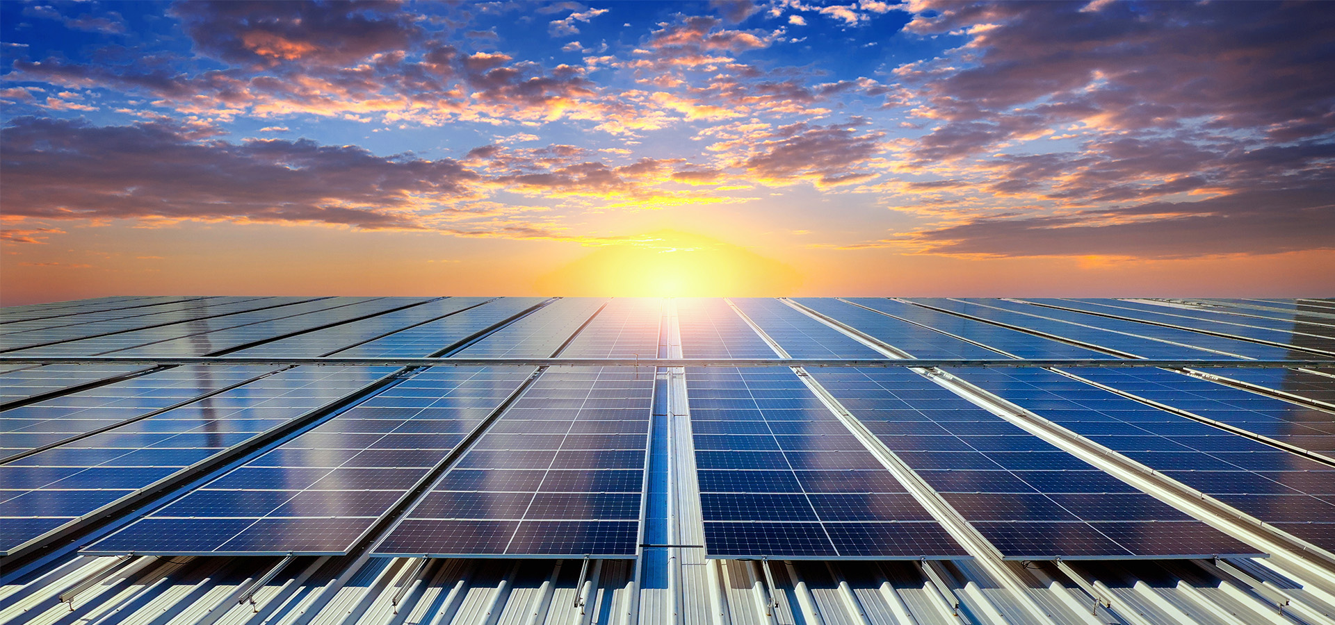 Solar array on an industrial rooftop at sunrise